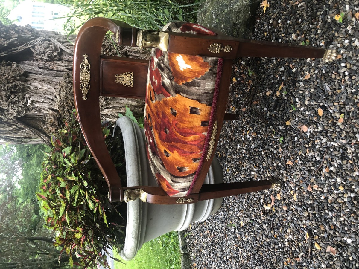Antique chair upholstered in an orange and burgundy patterned textile by Hilary Beadall.