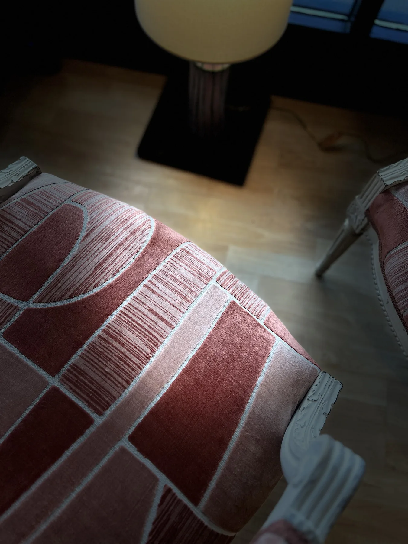 Close detail of the geometric upholstery on the chair seat.
