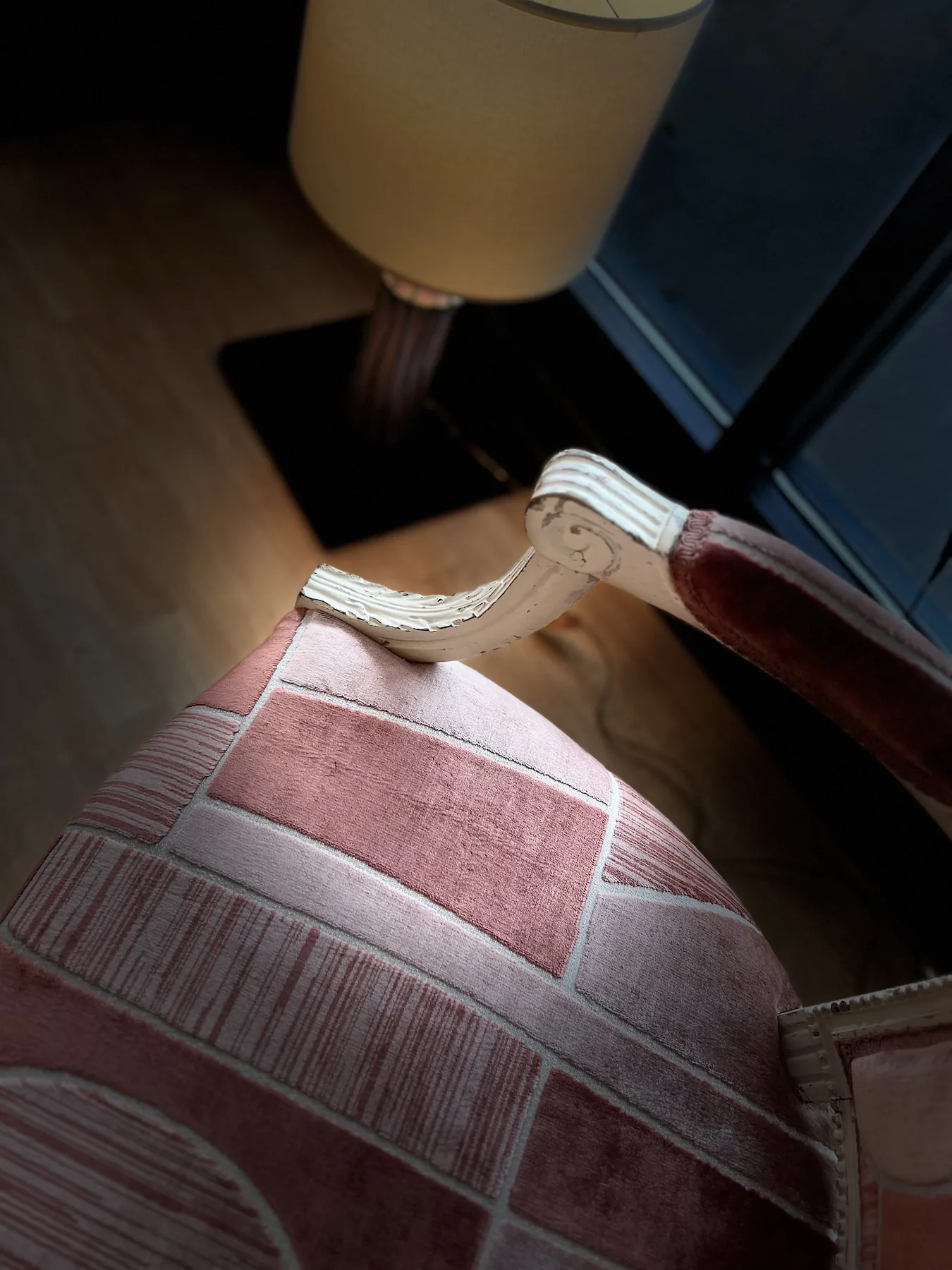 Close detail of the reupholstered chair back and carved frame.