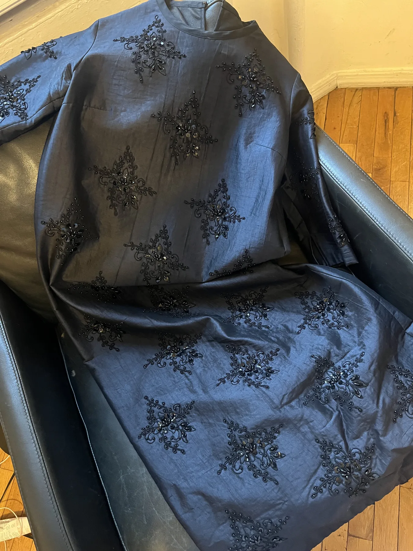 Close view of a dark blue Junya Watanabe textile with floral detailing.